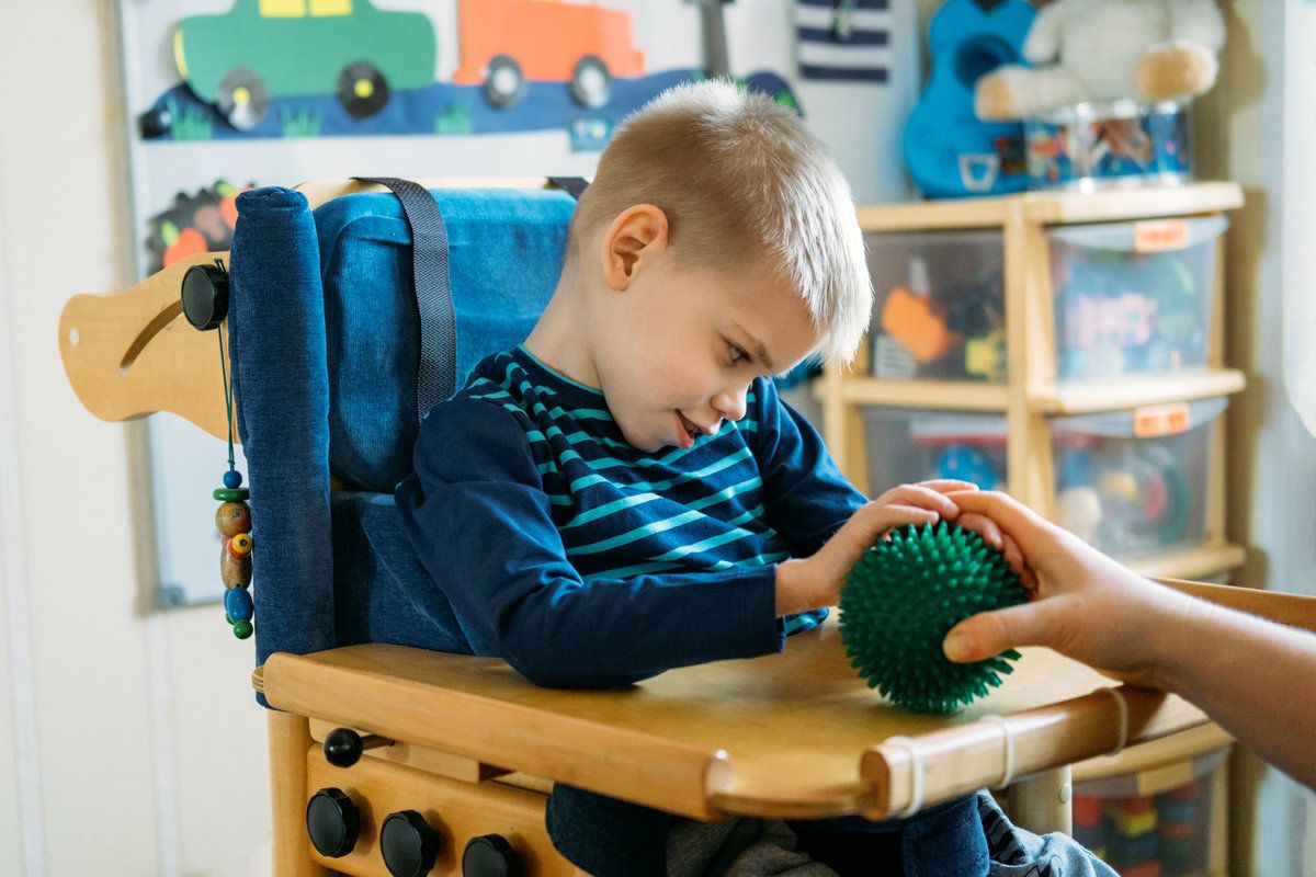 Child engaging with sensory activities in a calm, sensory-friendly dental office setting